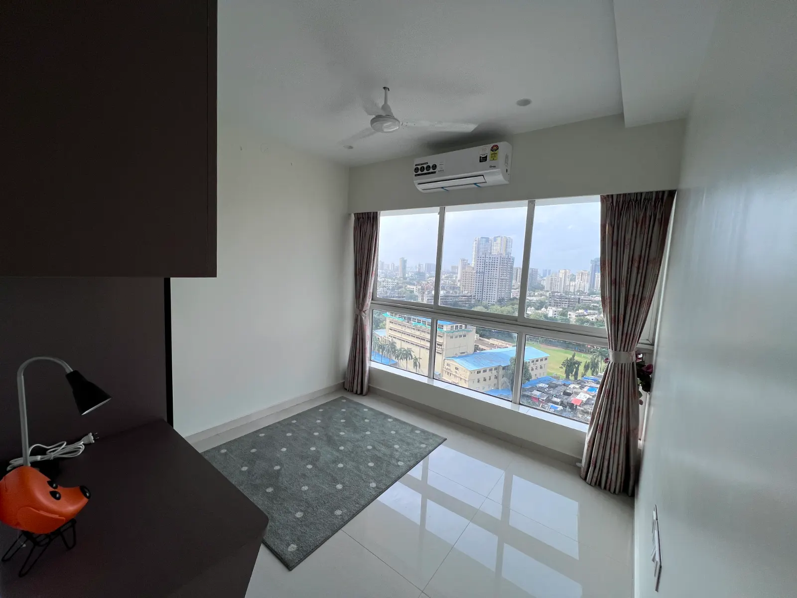 Second bedroom with city views at Bhavya Elite